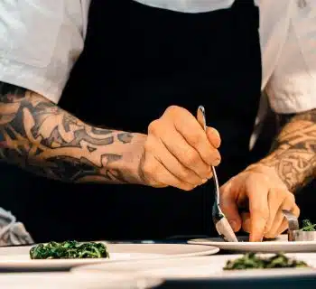 person putting food on plate